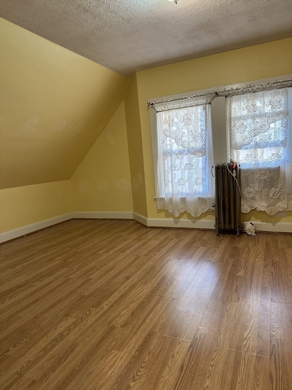 4 Ruthven Street Boston, MA 02121 - Photo 11 of 19 a view of an empty room with wooden floor and a window