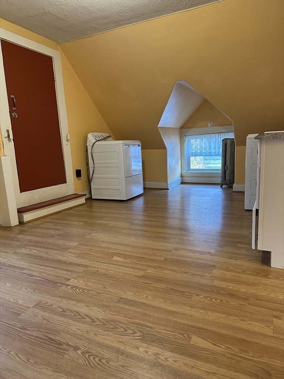 4 Ruthven Street Boston, MA 02121 - Photo 12 of 19 a view of an empty room with wooden floor and a cabinet