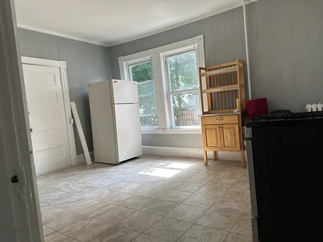 a view of an empty room with a fireplace