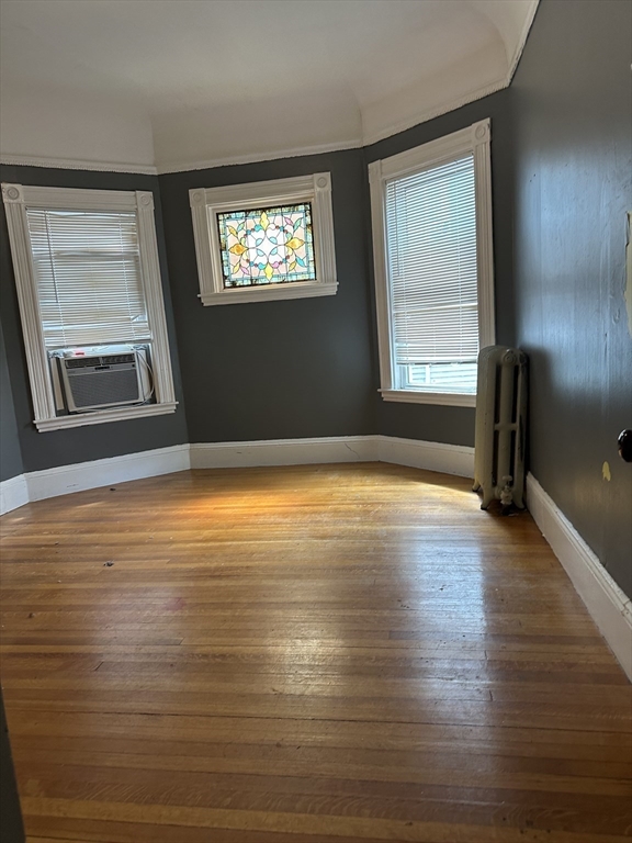 4 Ruthven Street Boston, MA 02121 - Photo 8 of 19 a view of an empty room with wooden floor and a window