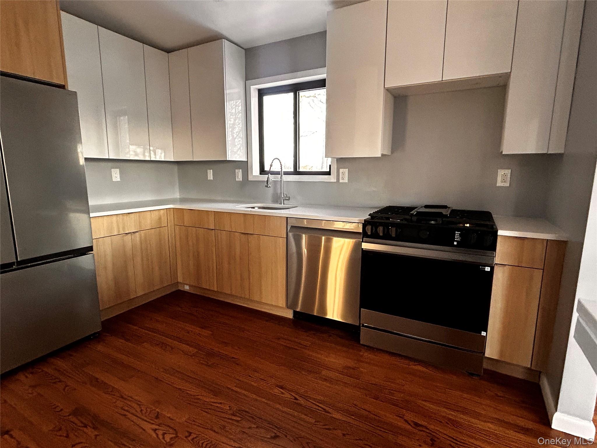 218 Beattie Road Washingtonville, NY 10992 - Photo 5 of 15 Kitchen featuring stainless steel appliances, dark wood finished floors, and modern cabinets