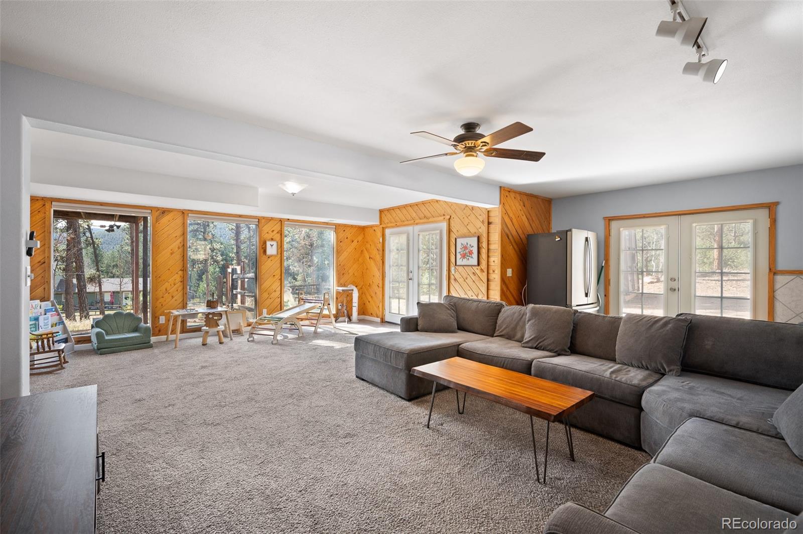 560 Gunsmoke Drive Bailey, CO 80421 - Photo 19 of 43 a living room with furniture and large windows