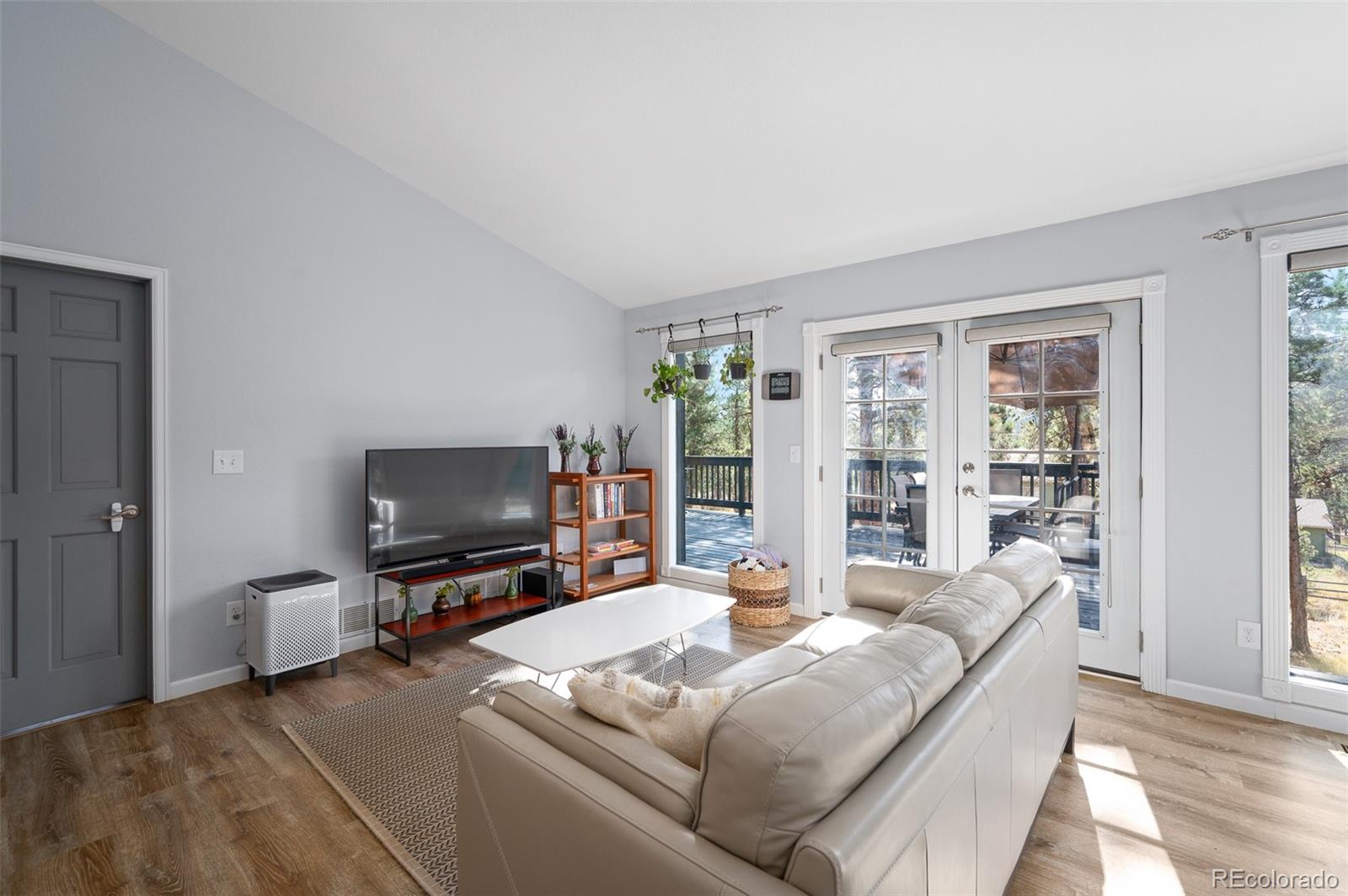 560 Gunsmoke Drive Bailey, CO 80421 - Photo 2 of 43 a living room with furniture and a flat screen tv