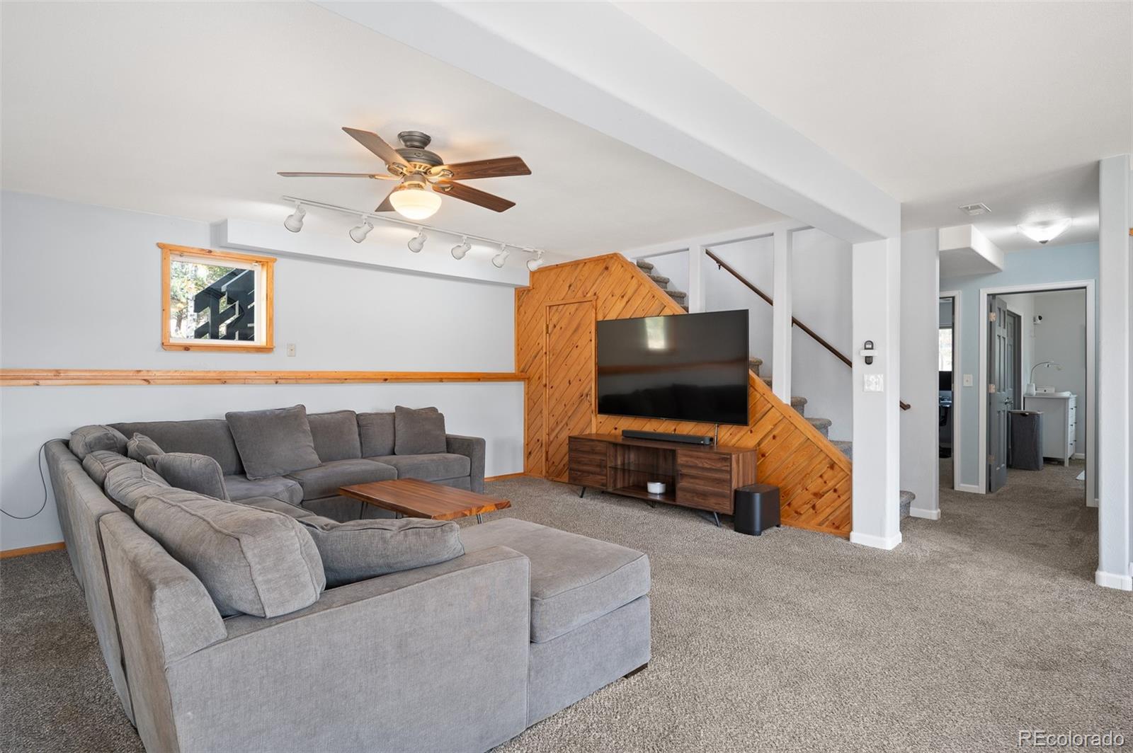560 Gunsmoke Drive Bailey, CO 80421 - Photo 21 of 43 a living room with furniture and a flat screen tv