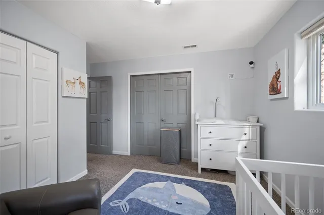 a view of a bedroom with furniture and window