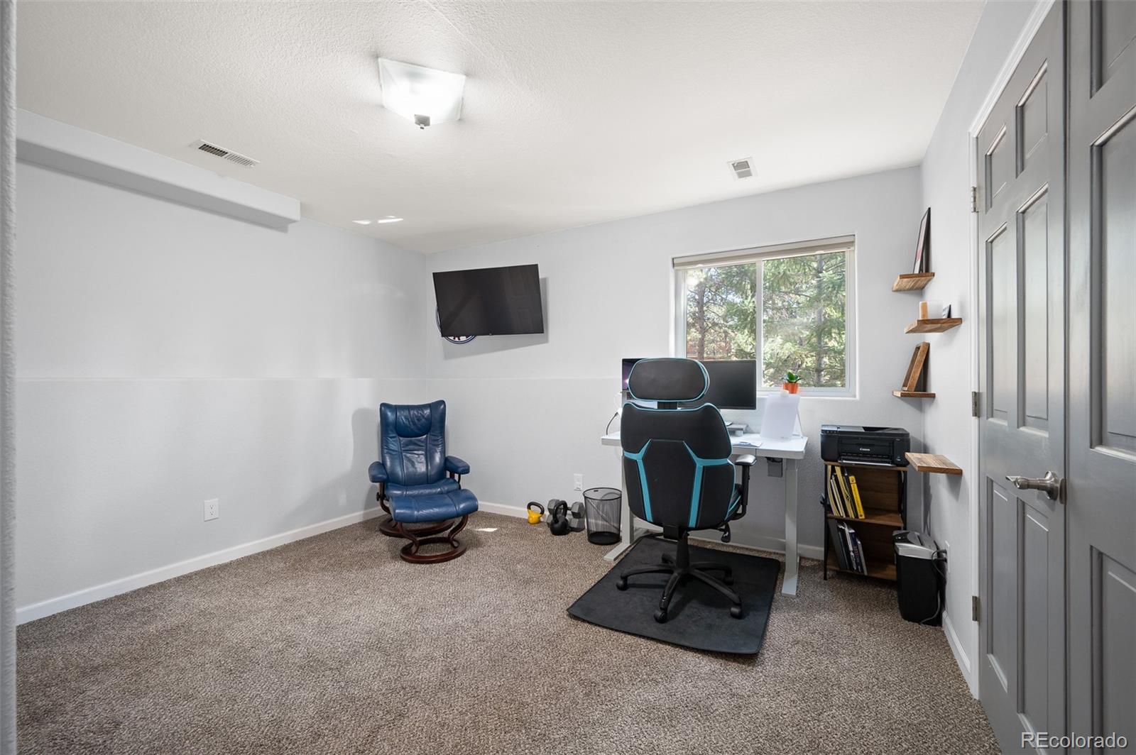 560 Gunsmoke Drive Bailey, CO 80421 - Photo 26 of 43 a view of a workspace with furniture and a window