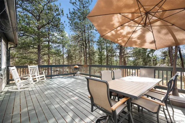 a view of a deck with chairs and wooden floor