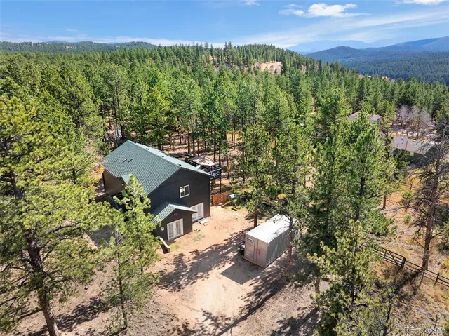 an aerial view of a house with a yard