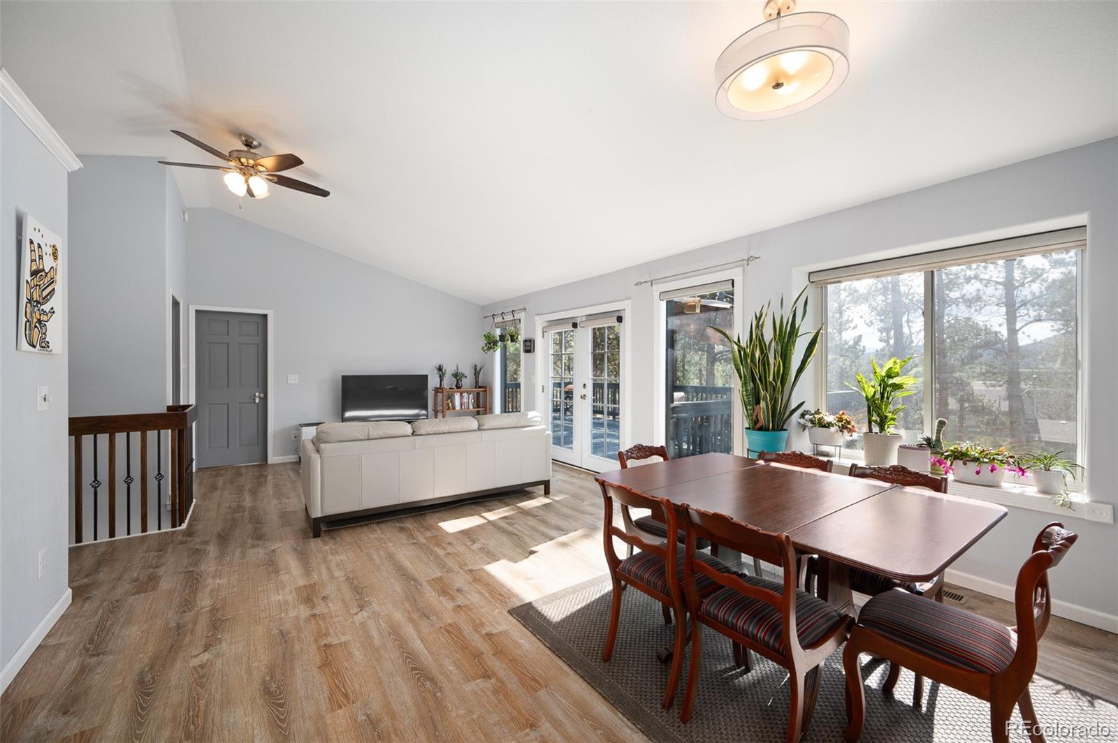 560 Gunsmoke Drive Bailey, CO 80421 - Photo 6 of 43 a dining room with furniture a chandelier and wooden floor