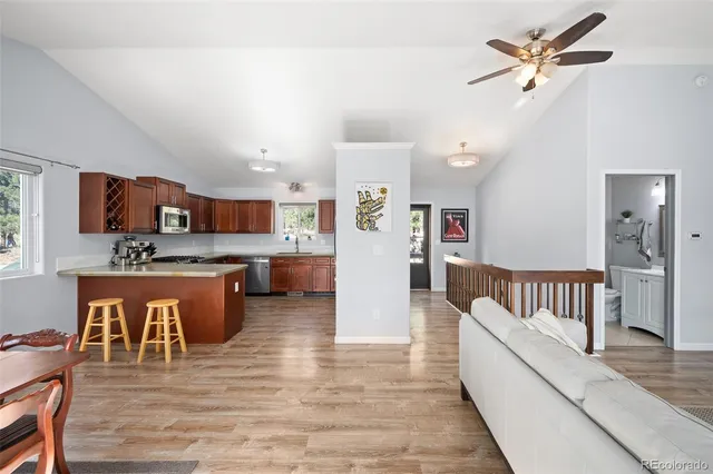 a living room with stainless steel appliances kitchen island granite countertop furniture and a kitchen view