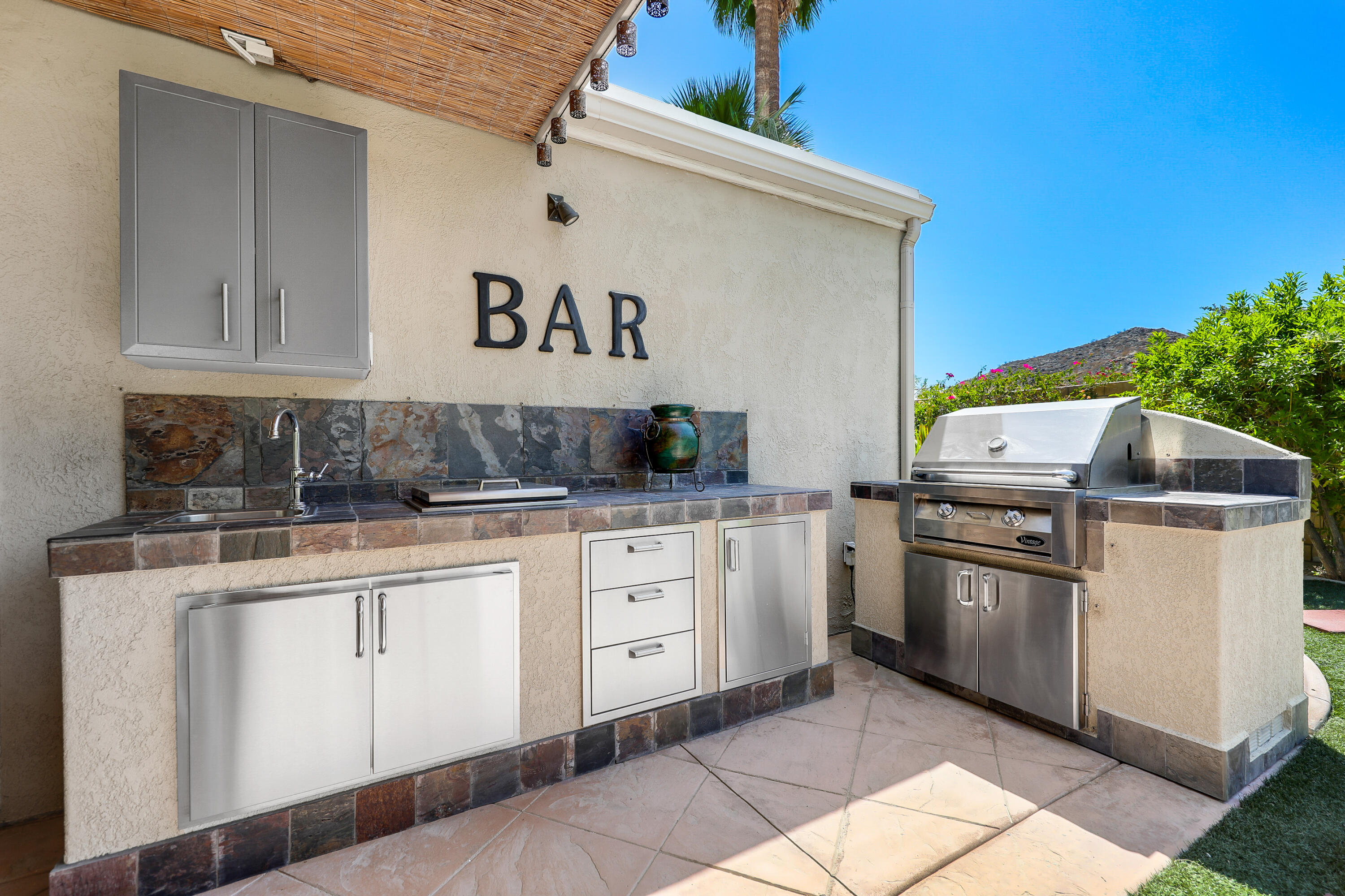 71601 Halgar Road Rancho Mirage, CA 92270 - Photo 14 of 35 a kitchen with stainless steel appliances granite countertop a stove a sink and a refrigerator