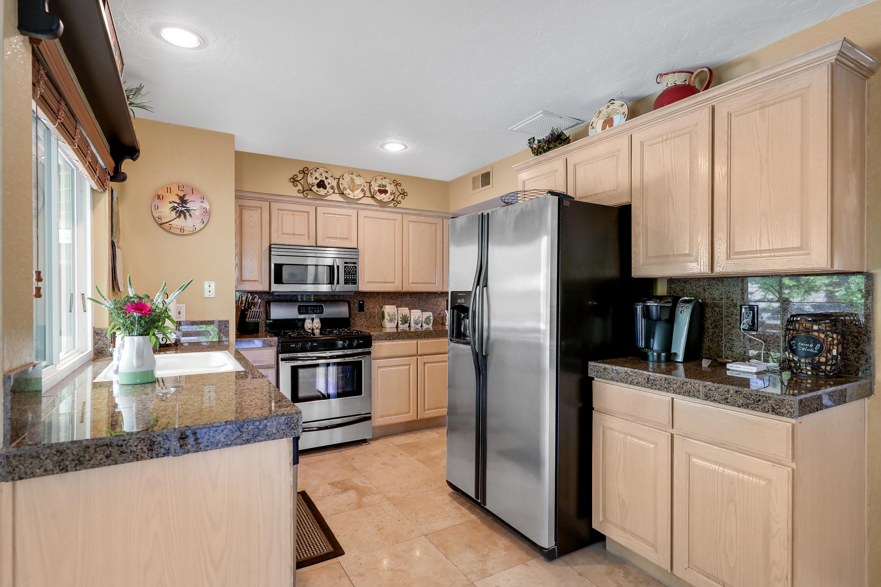 71601 Halgar Road Rancho Mirage, CA 92270 - Photo 17 of 35 a kitchen with granite countertop a refrigerator stove and sink