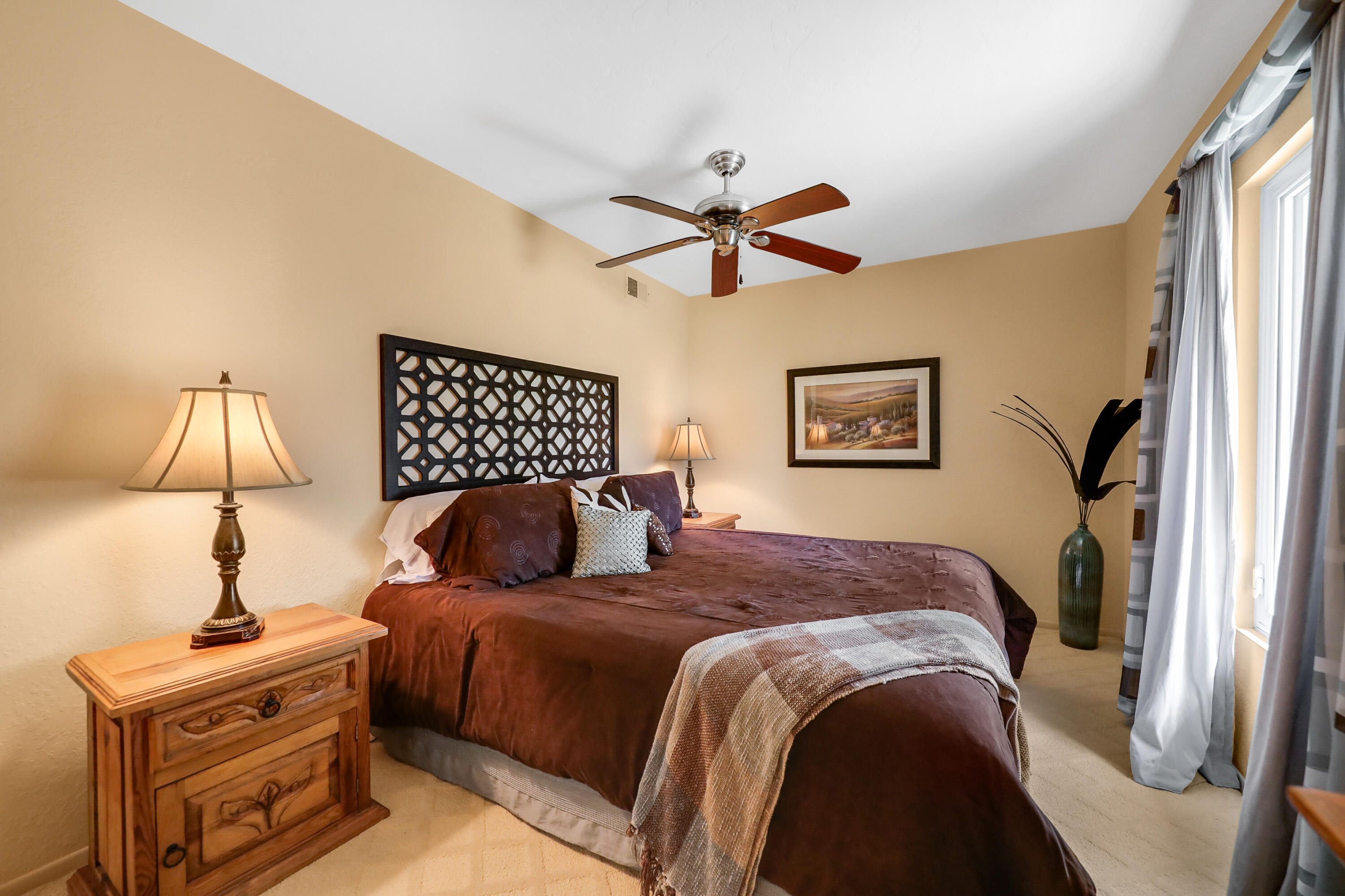71601 Halgar Road Rancho Mirage, CA 92270 - Photo 19 of 35 a bedroom with a large bed and a chandelier