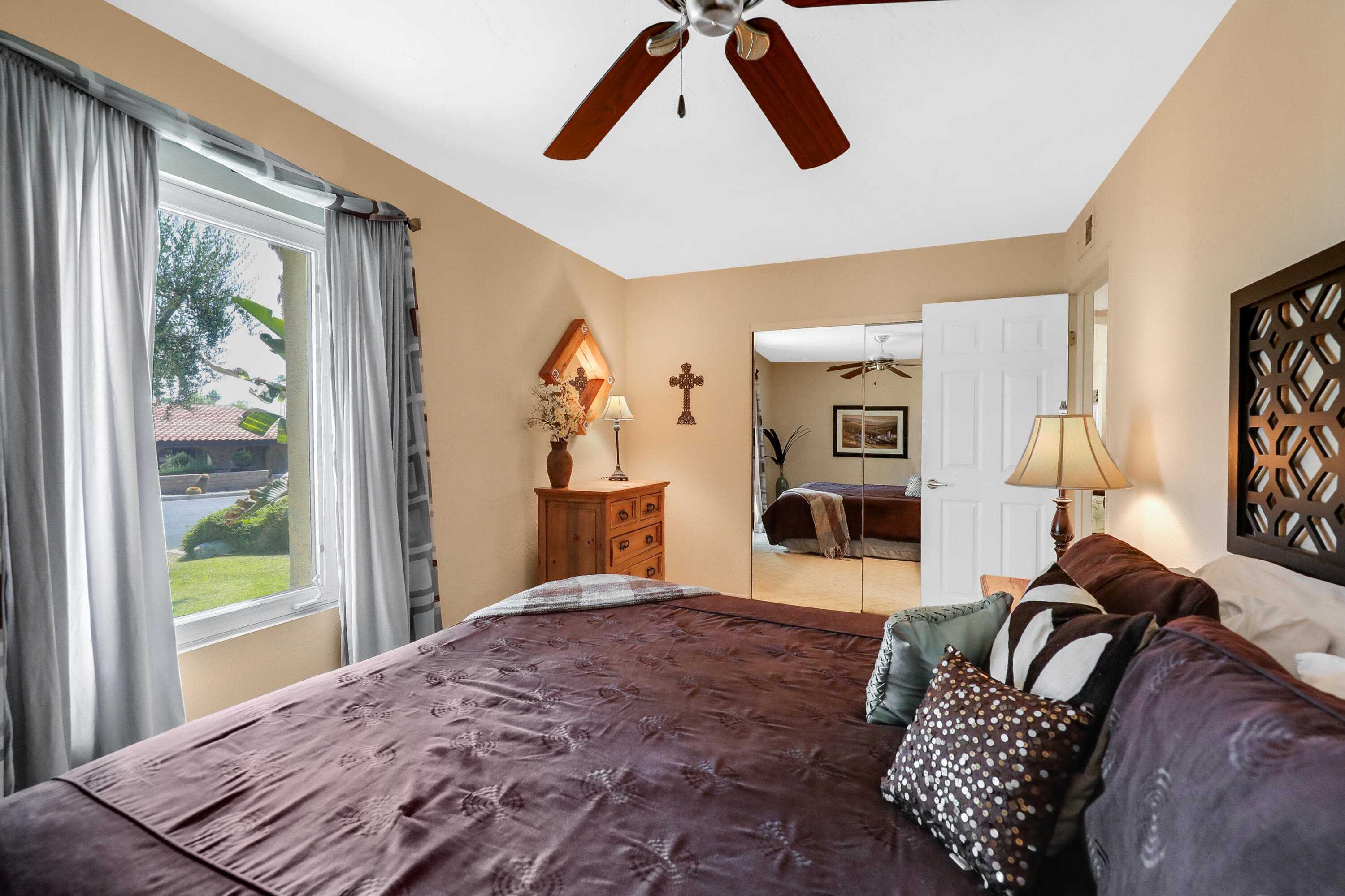 71601 Halgar Road Rancho Mirage, CA 92270 - Photo 20 of 35 a bedroom with a large bed and a window