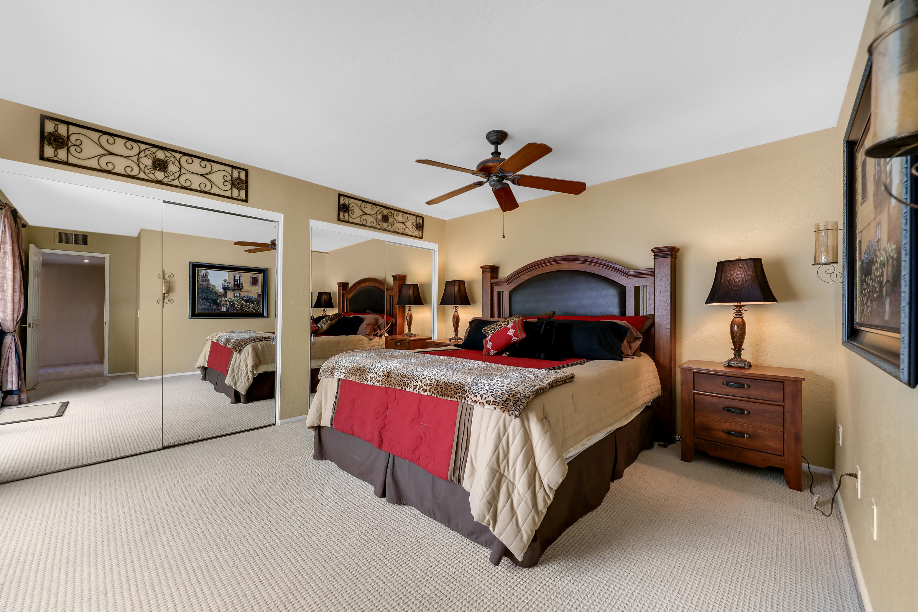 71601 Halgar Road Rancho Mirage, CA 92270 - Photo 24 of 35 a bedroom with bed and a chandelier