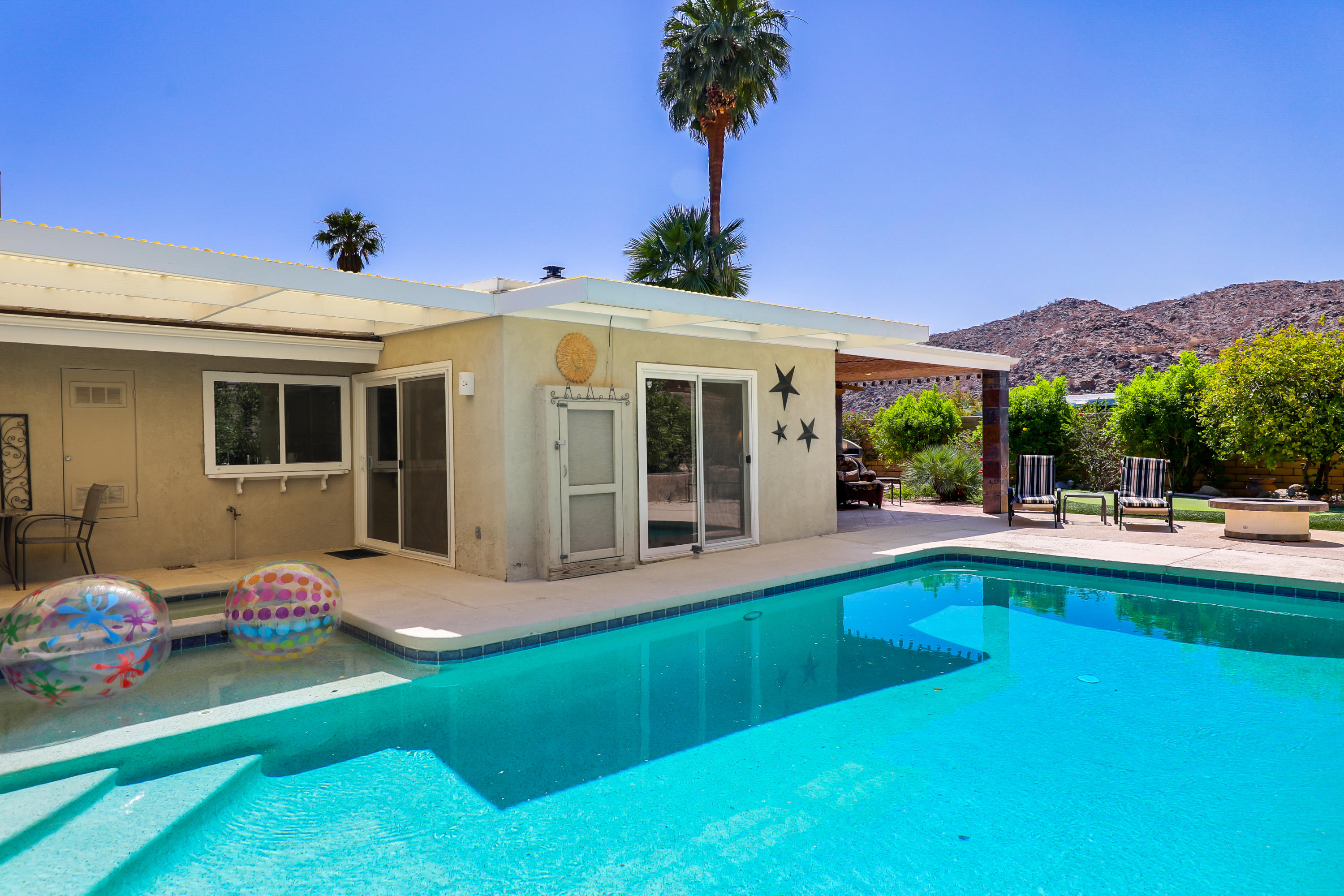 71601 Halgar Road Rancho Mirage, CA 92270 - Photo 30 of 35 a view of house with swimming pool outdoor seating