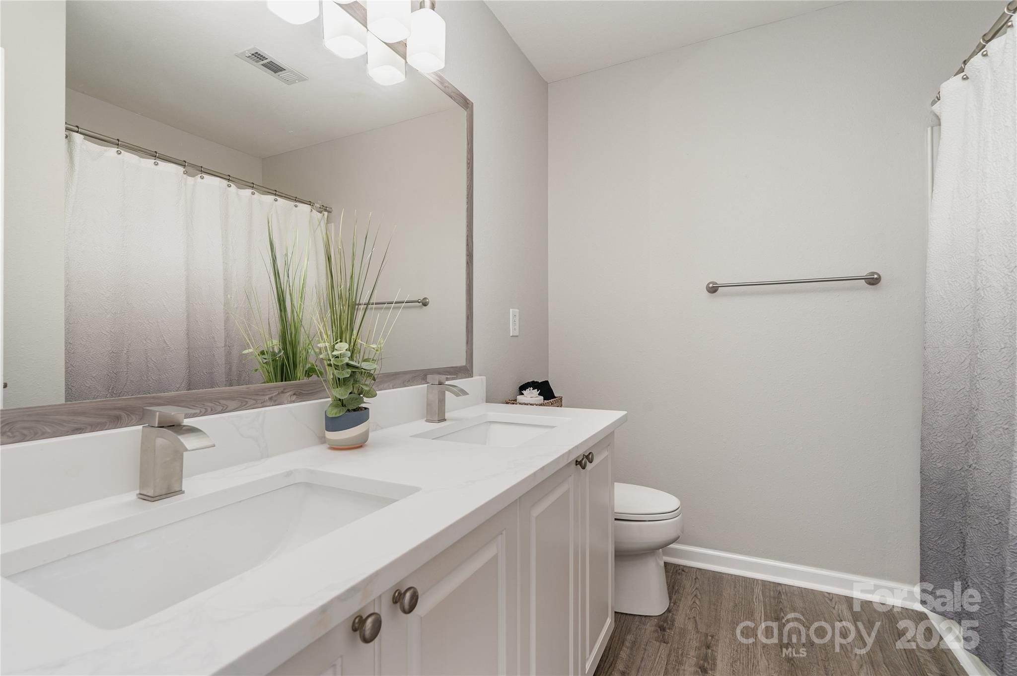 2919 Heather Ridge Road Dallas, NC 28034 - Photo 17 of 24 a bathroom with a sink and a mirror