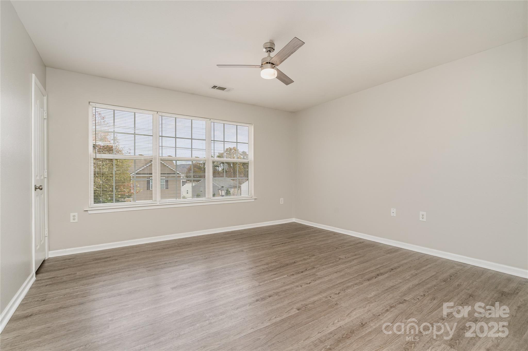 2919 Heather Ridge Road Dallas, NC 28034 - Photo 18 of 24 an empty room with wooden floor and windows