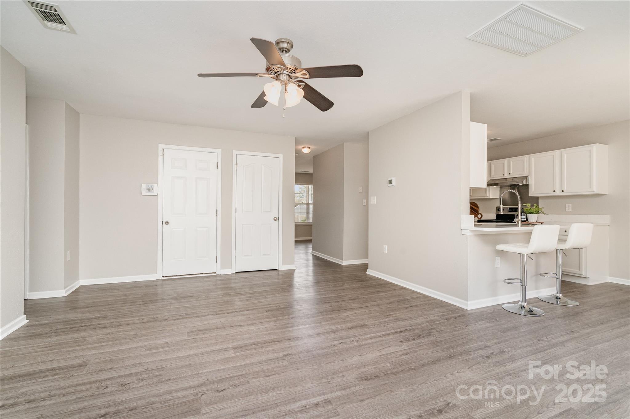 2919 Heather Ridge Road Dallas, NC 28034 - Photo 3 of 24 a view of a kitchen with wooden floor and a ceiling fan