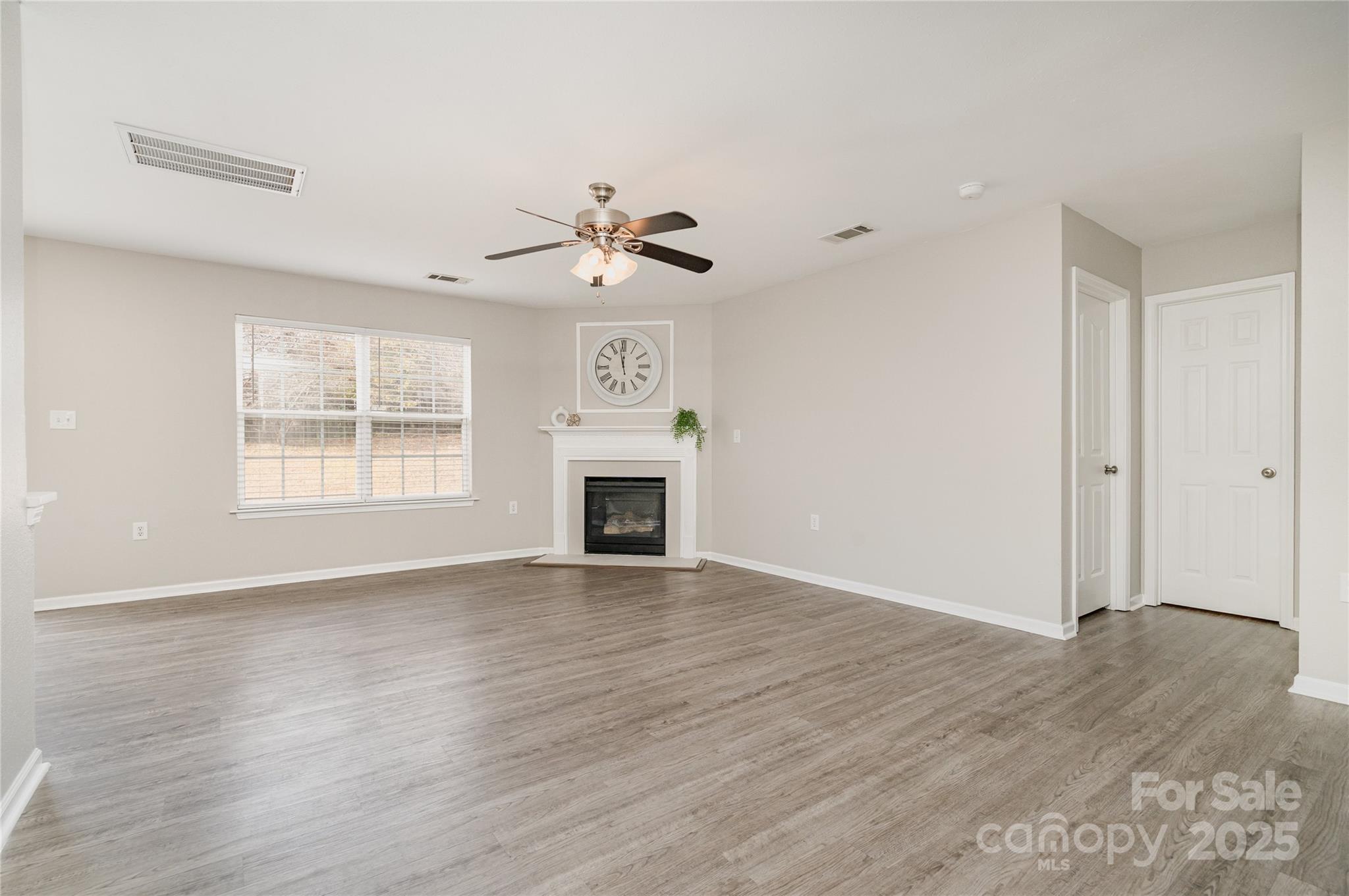 2919 Heather Ridge Road Dallas, NC 28034 - Photo 4 of 24 wooden floor in an empty room with a window