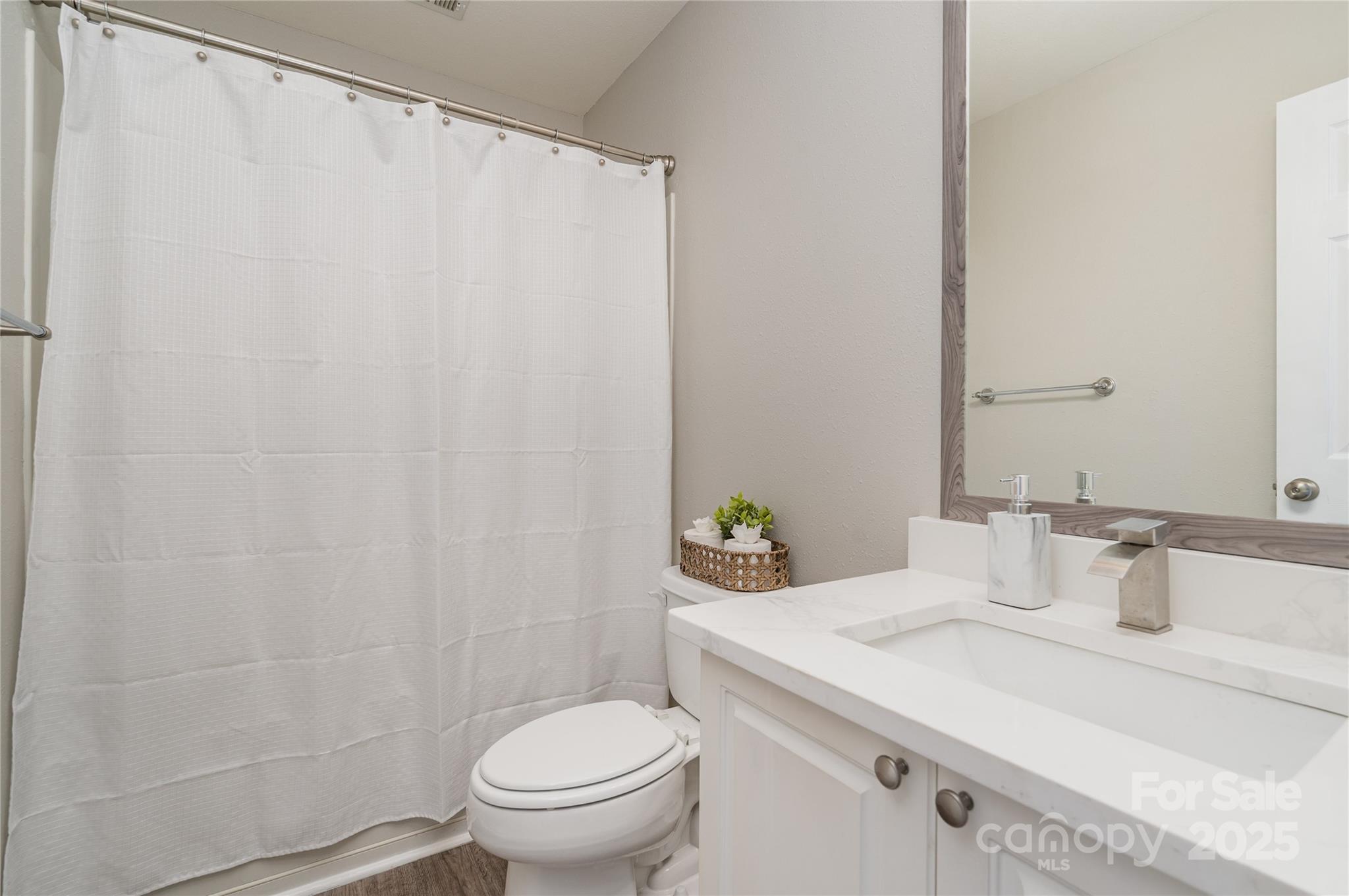 2919 Heather Ridge Road Dallas, NC 28034 - Photo 9 of 24 a bathroom with a granite countertop sink and a toilet
