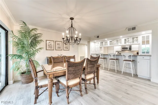 a view of a dining room with furniture and chandelier