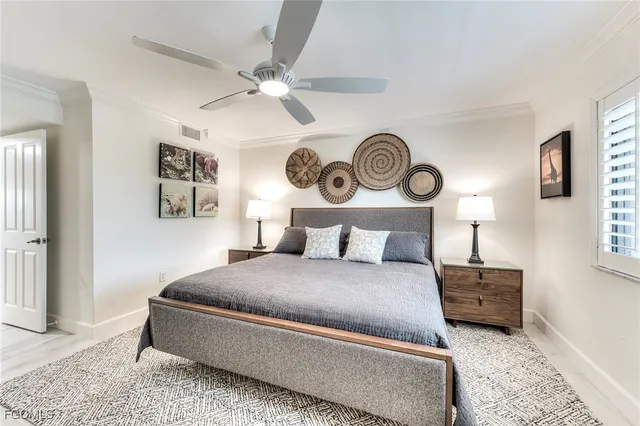 a bedroom with a bed and painting on the wall