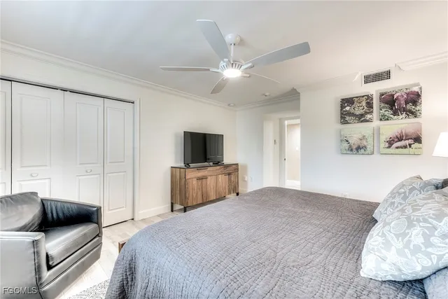 a bedroom with a bed and a television