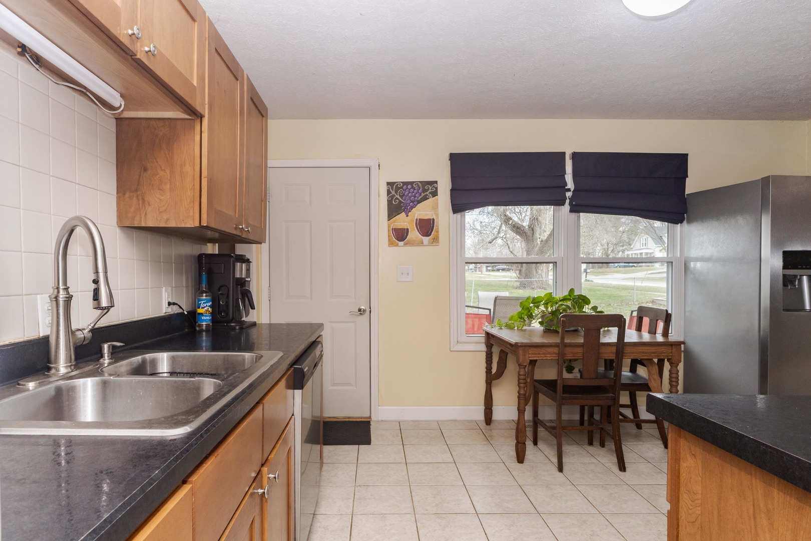 1400 Kingsridge Drive Normal, IL 61761 - Photo 6 of 31 a kitchen with granite countertop a sink and a refrigerator