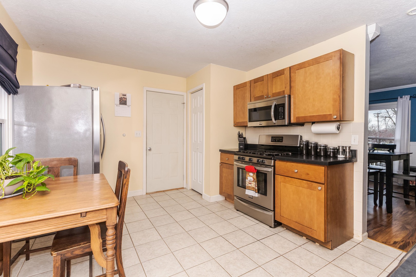 1400 Kingsridge Drive Normal, IL 61761 - Photo 9 of 31 a kitchen with stainless steel appliances granite countertop a refrigerator a stove a sink a dining table and chairs