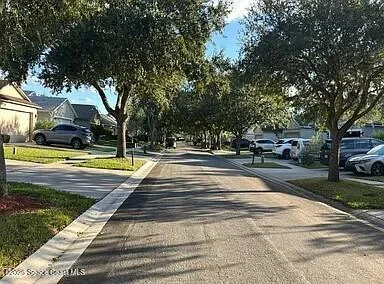a view of a swimming pool and trees in the background