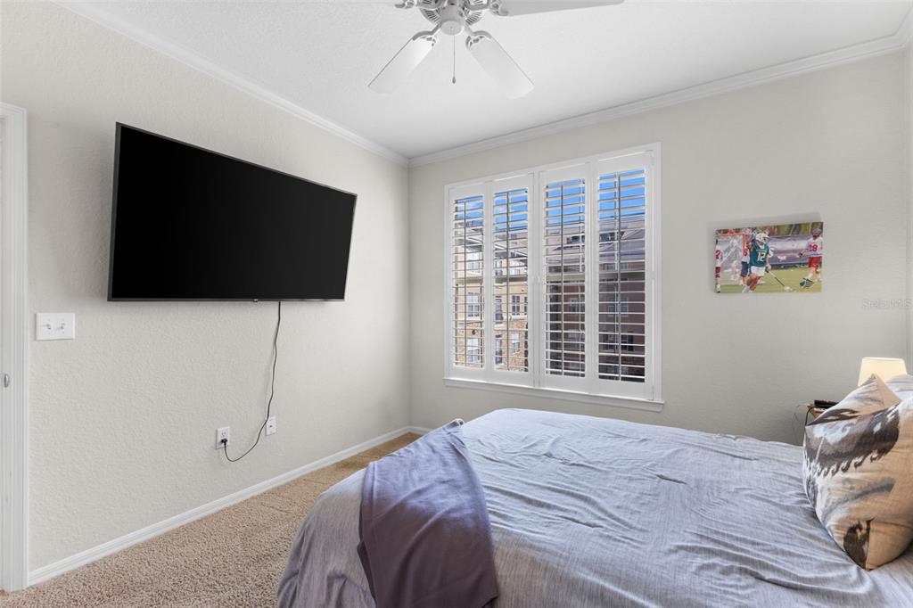 4221 West Spruce Street, Unit 1326 Tampa, FL 33607 - Photo 24 of 45 a bedroom with a bed and a flat screen tv