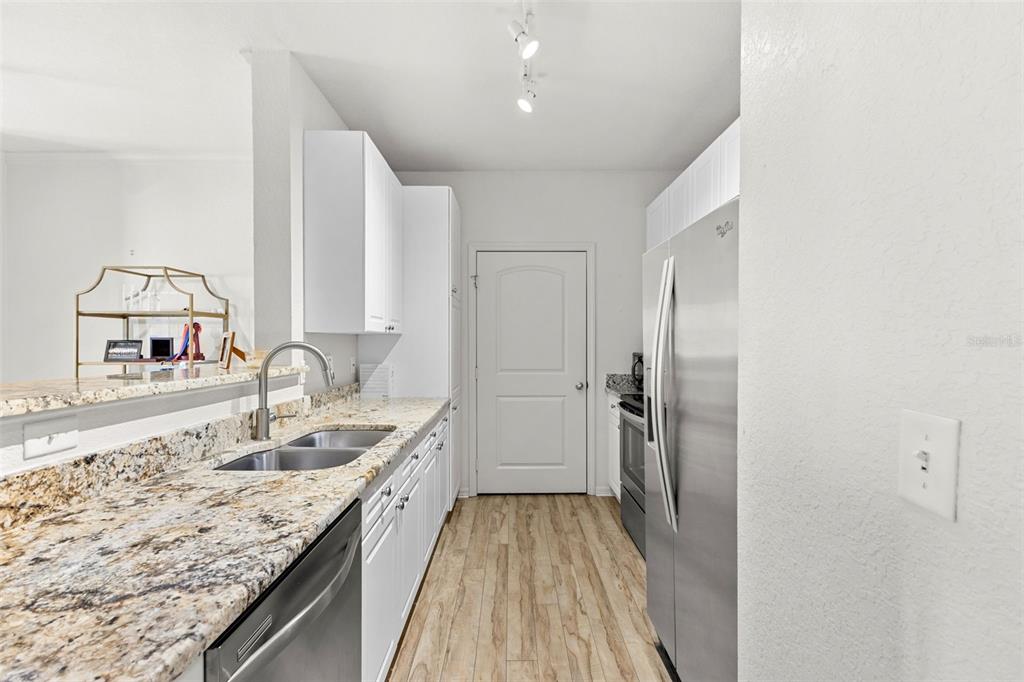 4221 West Spruce Street, Unit 1326 Tampa, FL 33607 - Photo 26 of 45 a spacious bathroom with a granite countertop sink a mirror and shower