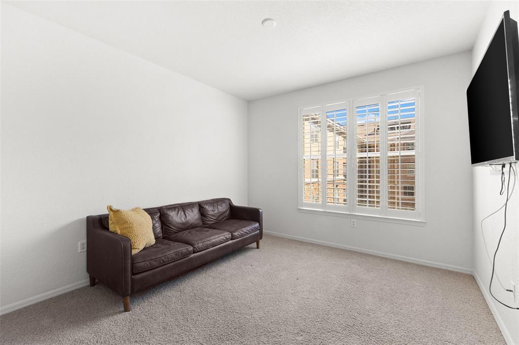 4221 West Spruce Street, Unit 1326 Tampa, FL 33607 - Photo 29 of 45 a living room with furniture and a flat screen tv