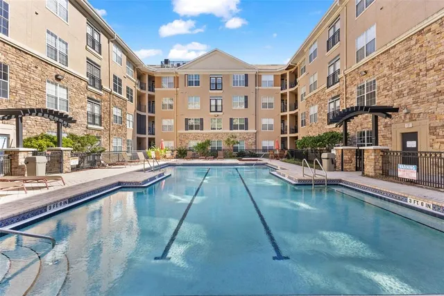 a view of a swimming pool with a lounge chairs