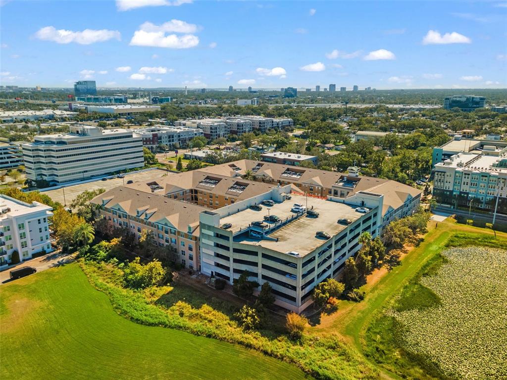 4221 West Spruce Street, Unit 1326 Tampa, FL 33607 - Photo 40 of 45 an aerial view of a house with a garden and lake view