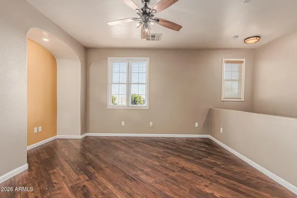 a view of a room with wooden floor and a window