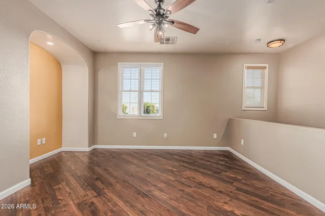 a view of a room with wooden floor and a window