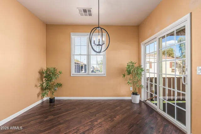 a view of room with wooden floor and potted plant