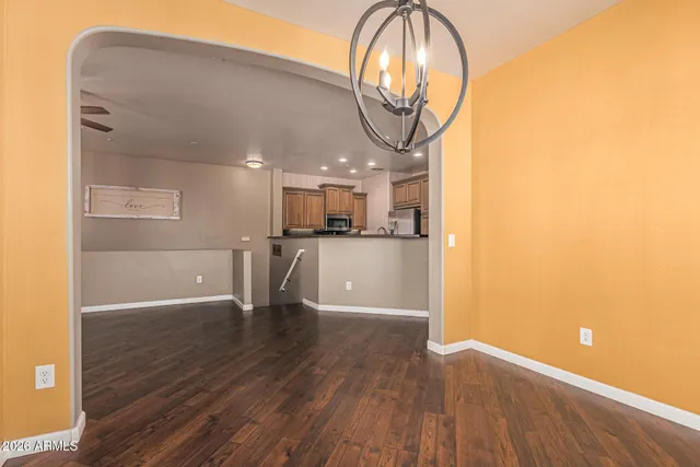 a view of kitchen with stainless steel appliances refrigerator stove microwave and cabinets