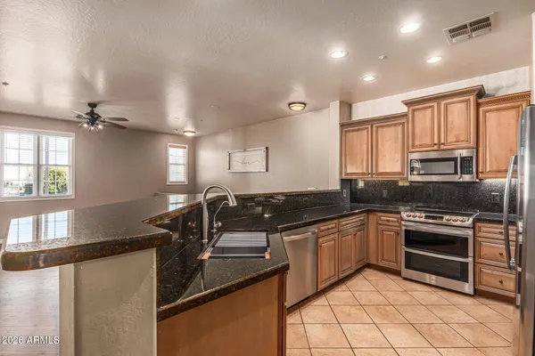 a kitchen with granite countertop a sink and cabinets