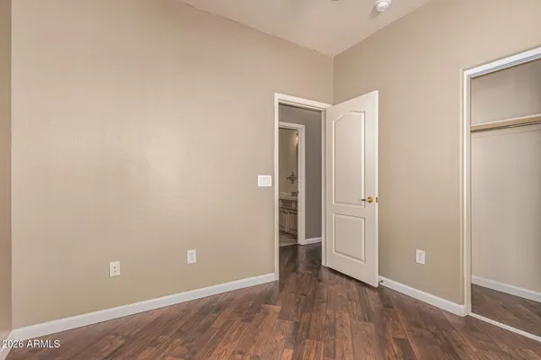 a bathroom with a granite countertop sink a toilet and a mirror