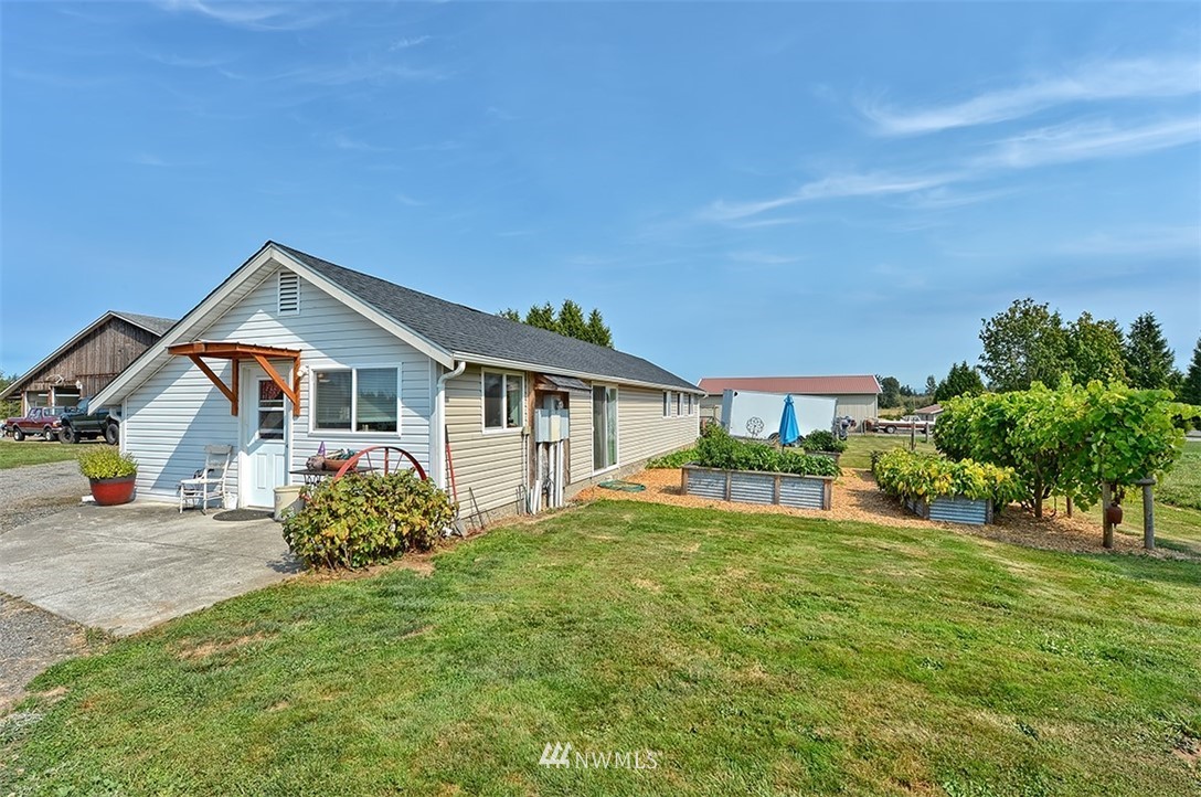 3668 Bay Road Ferndale, WA 98248 - Photo 19 of 40 a front view of a house with a yard and garage