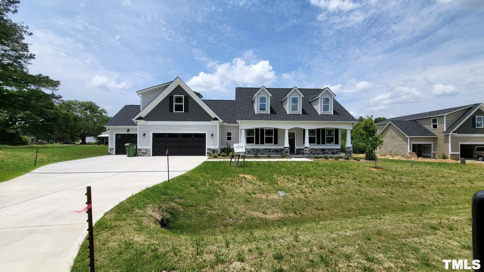 33 Crystal Spgs Way Benson, NC 27504 - Photo 1 of 15 a front view of a house with a garden