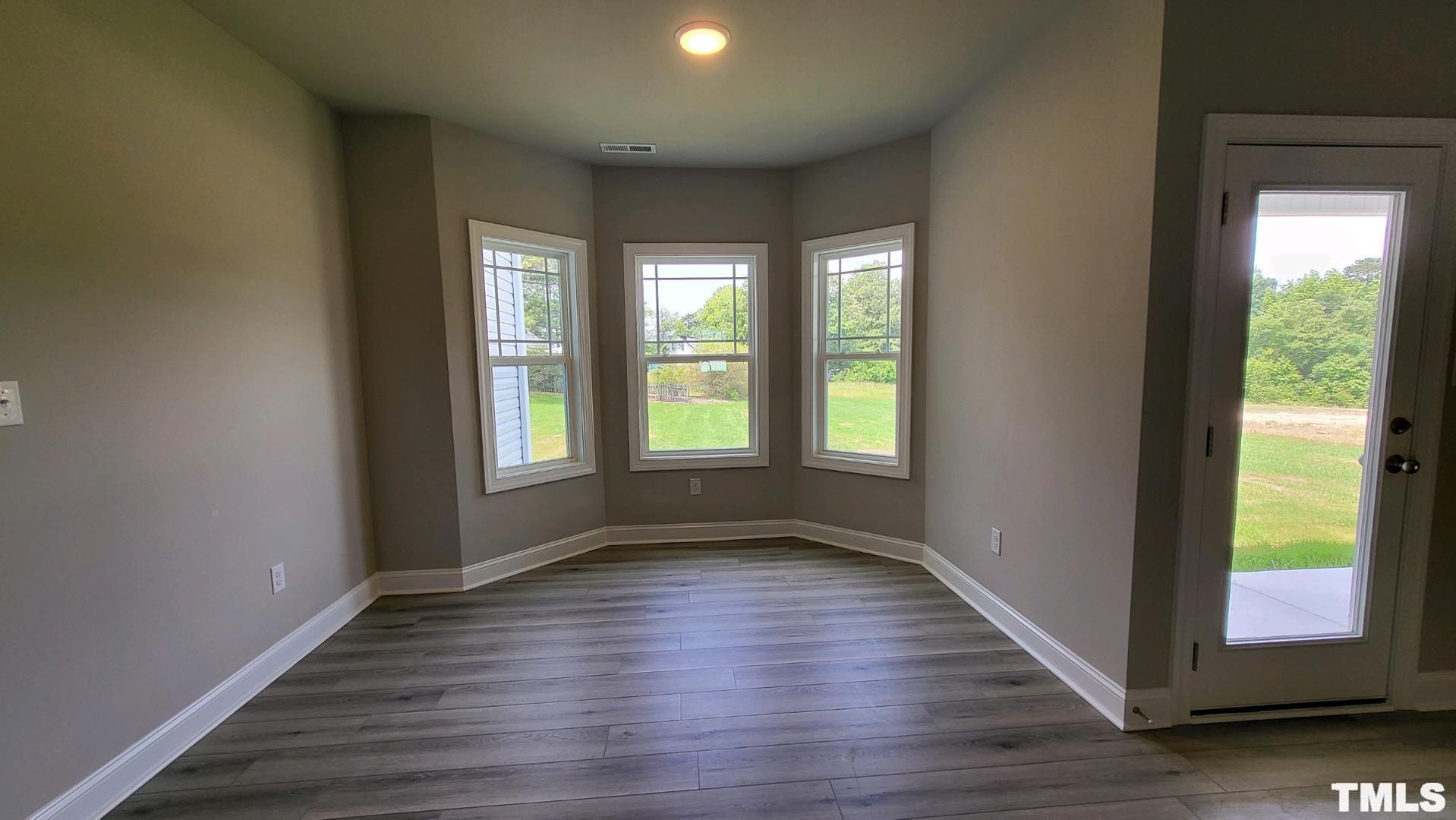 33 Crystal Spgs Way Benson, NC 27504 - Photo 6 of 15 a view of an empty room with wooden floor and a window