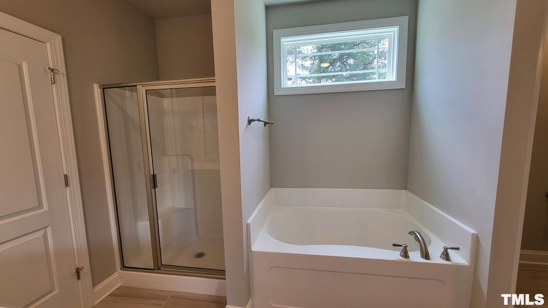 33 Crystal Spgs Way Benson, NC 27504 - Photo 9 of 15 a bathroom with a bathtub and a window