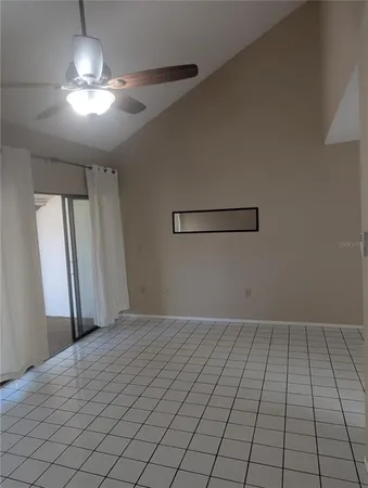 a view of a livingroom with an empty space and a window