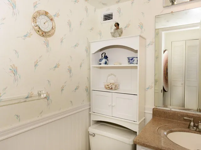 a bathroom with a sink a mirror and vanity
