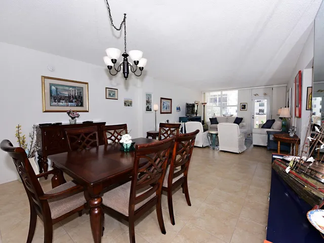 a view of a dining room with furniture and a chandelier