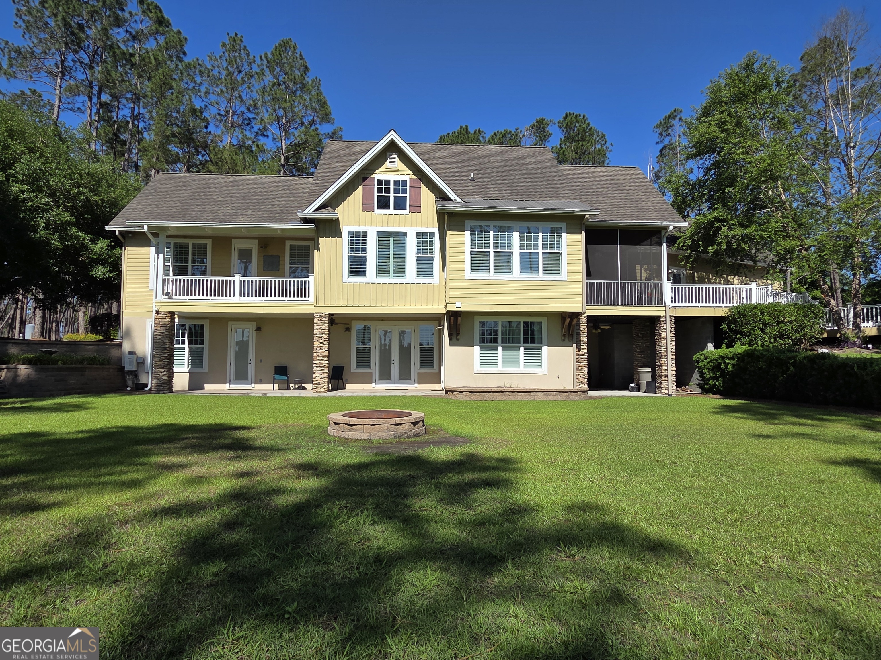 300 Hammond Powell Road Hazlehurst, GA 31539 - Photo 24 of 91 a front view of a house with a yard table and chairs